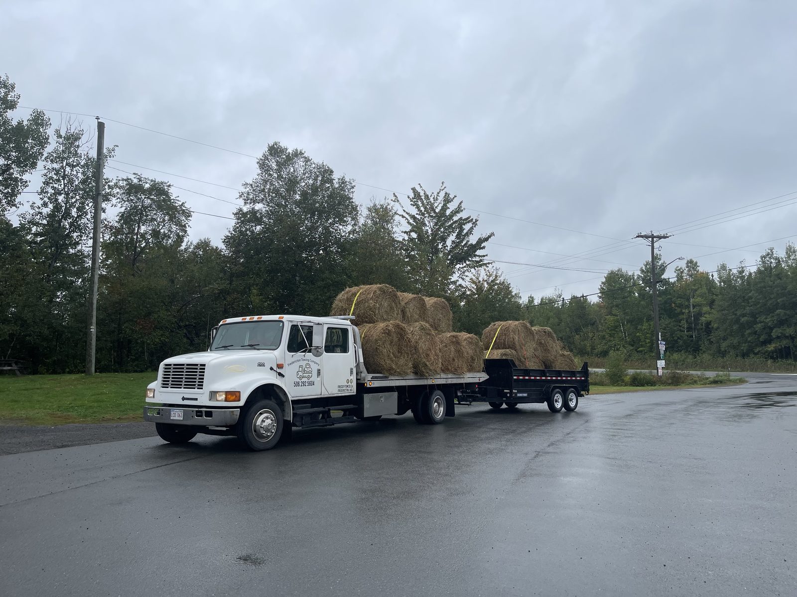 Freddy Tow Co. flatbed on a rural farm tow in the Fredericton, NB area.